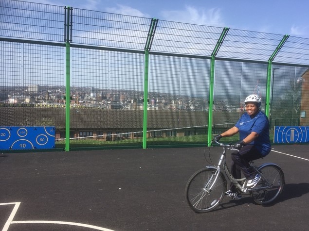 photo of woman cycling on a playground