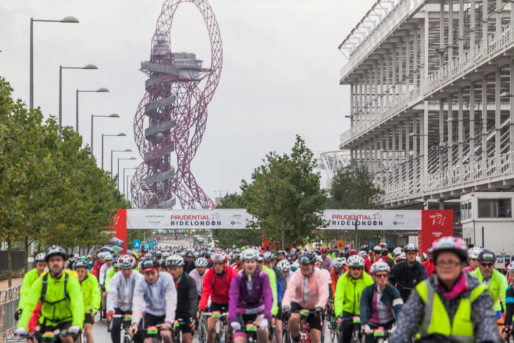 Riders at RideLondon 2014 with Anish Kapoor's Orbit tower in the background