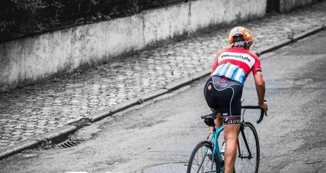 A female cyclist riding up hill