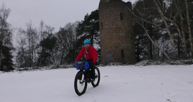 Cyclist bikepacking in the snow 