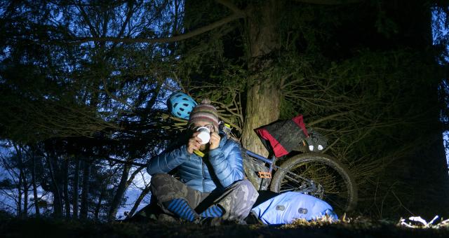 Bikepacking cyclist having a cup of tea 