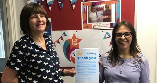 Julie presents office volunteer Stasi with her Thank You certificate