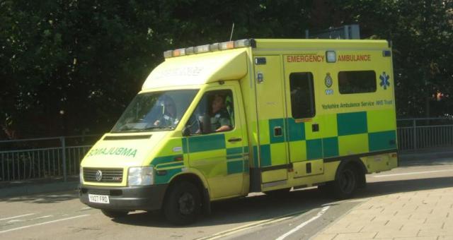 Ambulance driving by a bike lane