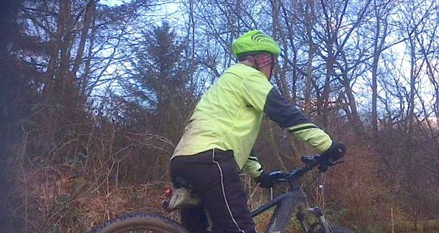 Man on e-bike facing away from camera