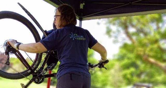 women working on bike which is on stand