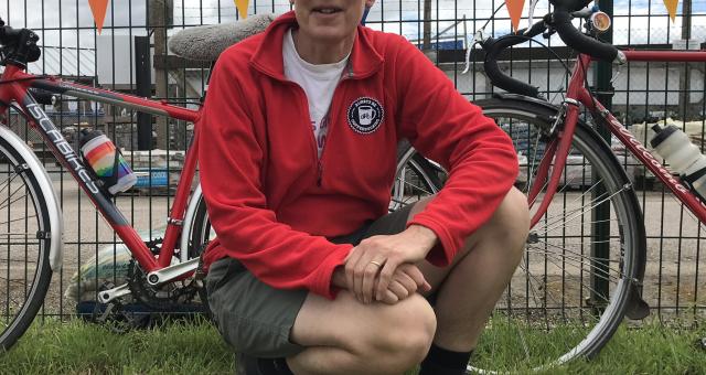 woman crouching down in front of bike