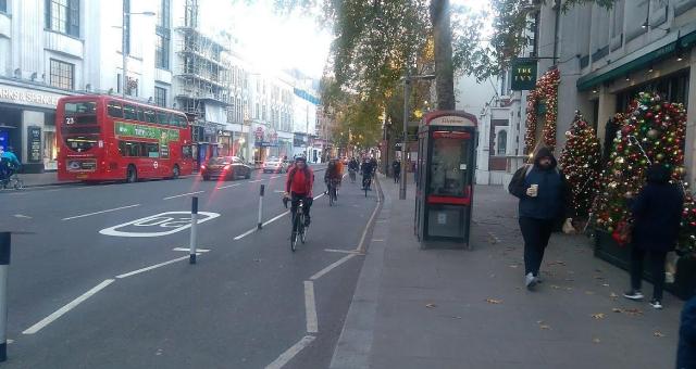 Cyclists make use of a segregated bike lane in London during Christmas time