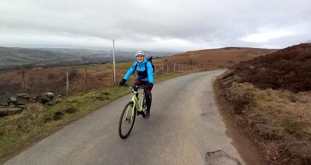 Simon ward smiles as he pedals a Making cycling e-asier e-cycle uphill