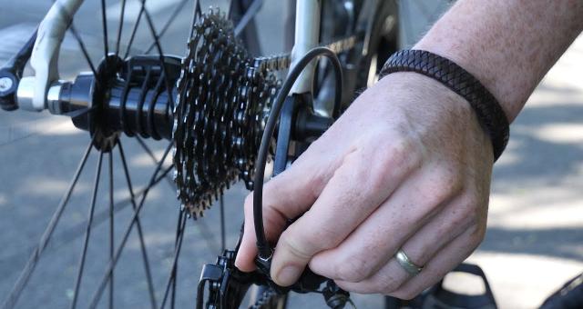 A cyclist performing roadside repairs. 